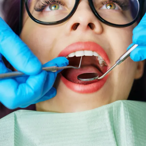 Dentist examining teeth and gums during a routine checkup