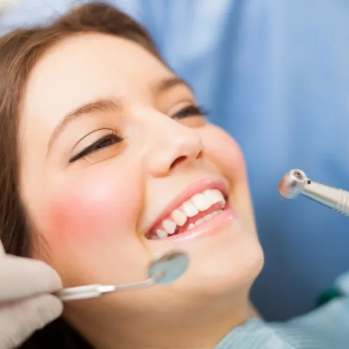 Dentist examining a tooth before dental filling treatment