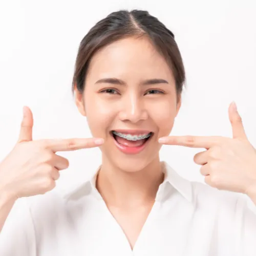 Patient with metal braces for teeth straightening at Smile Center Islamabad