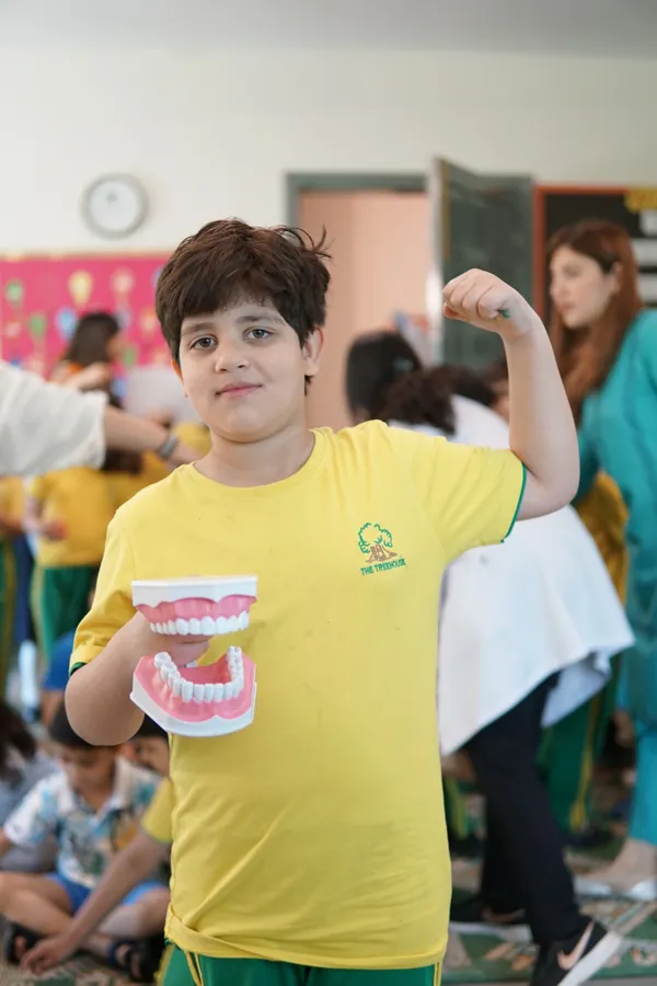 Child learning about teeth during pediatric dental awareness session at Smile Center Islamabad