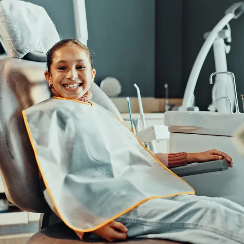 Young patient smiling in dental chair at Smile Center Islamabad